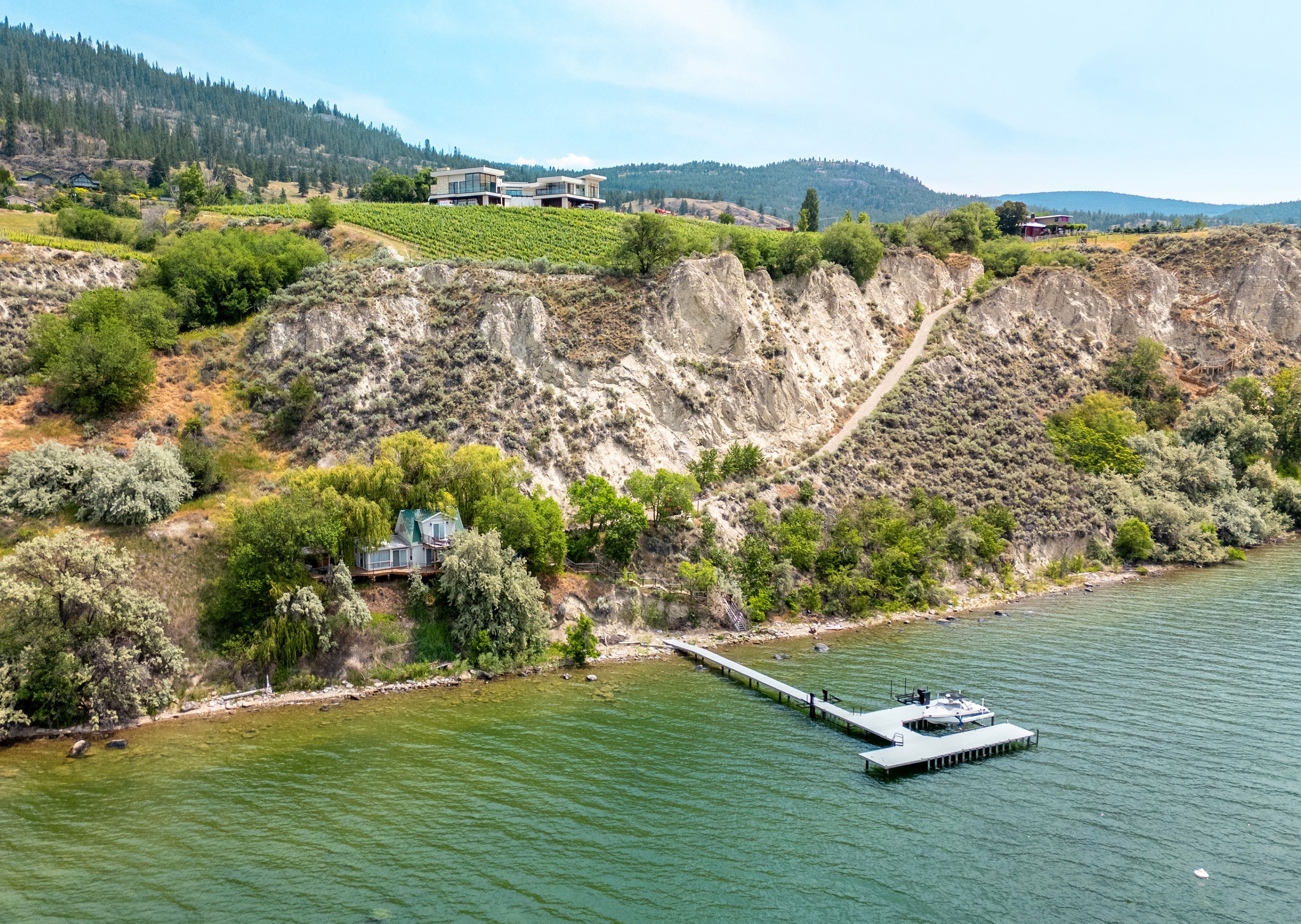 Contemporary vineyard estate above Okanagan Lake with a private dock in Penticton, British Columbia