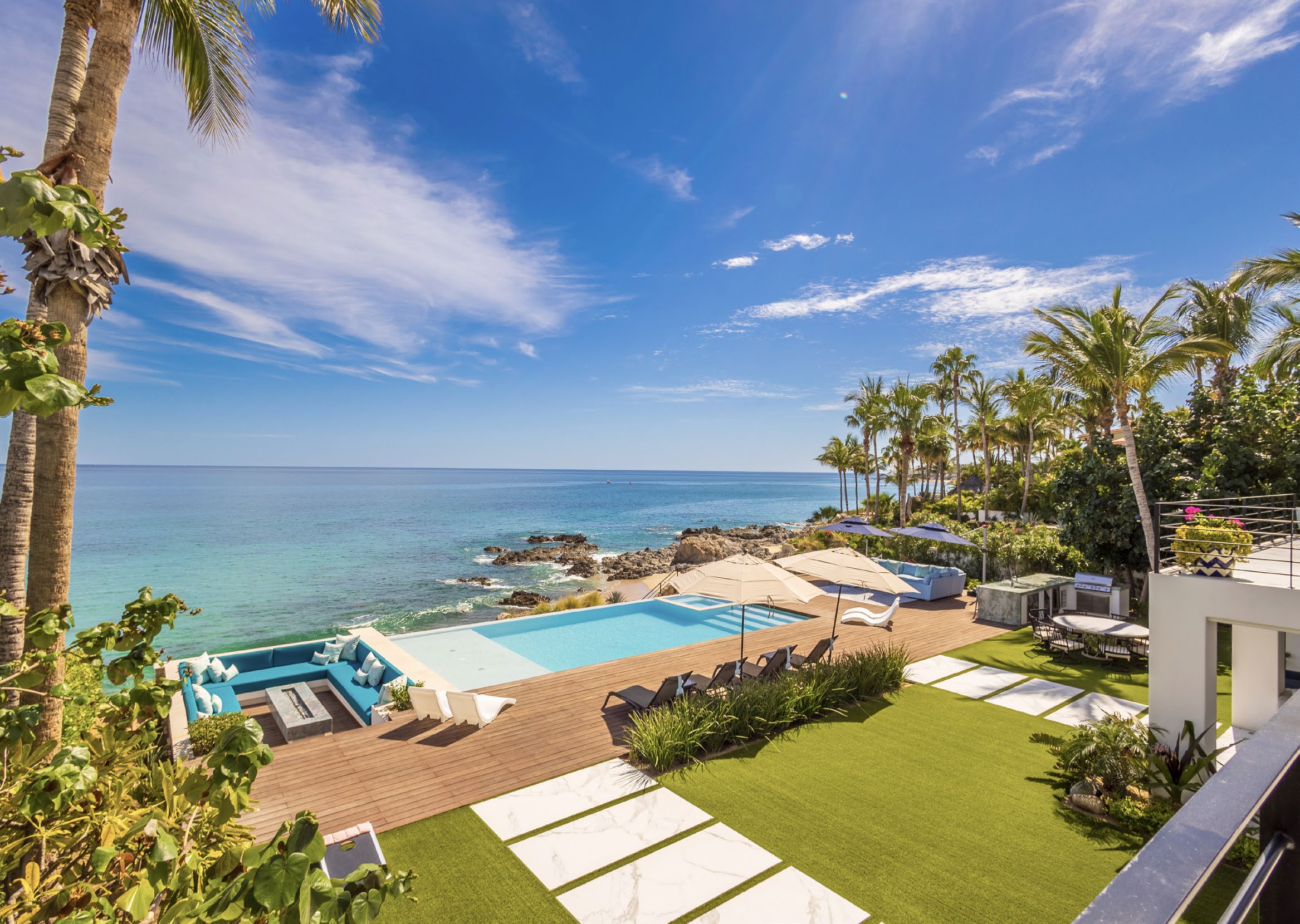 Oceanfront terrace with infinity pool and palms above a swimmable cove on the Sea of Cortez, San Jose Corridor, Mexico