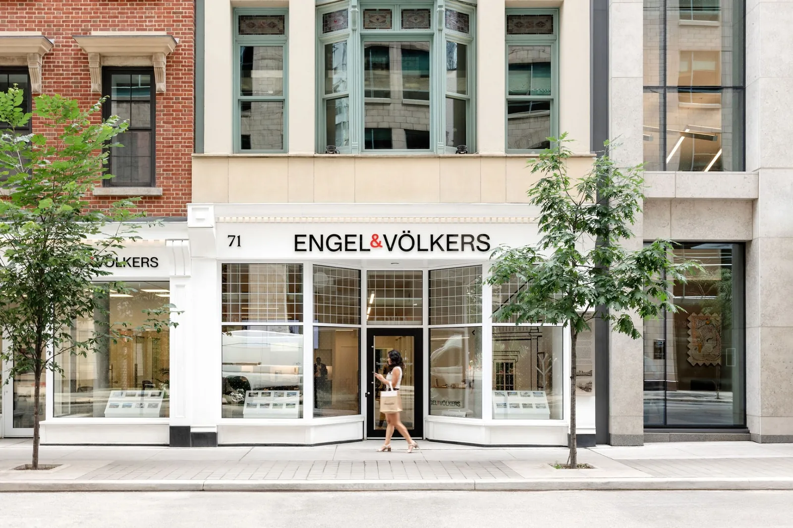 An Engel & Völkers Shop storefront on a tree-lined city street
